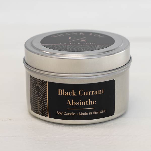 A wedding favor candle with black modern style label on the side of the candle 